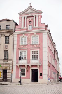 a pink and white building with a clock tower