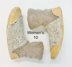 This listing features one pair of wool slippers made from high quality recycled garments. Durable, warm and breathable for any season. Fits ladies US size 10 *oatmeal/taupe lambswool with sand colored leather/suede. Lined with organic bamboo fleece. This Pair ships within in 1-3 days of purchase Spoil your feet with these warm cozy slipper boots lined with organic bamboo fleece. Inside there is a plush and soft faux FUR insole which will feel incredible on your feet and the felt padding sandwiched in between the insole and bottom soles will offer extra cushion on hard floors. Elastic stitched around the ankle of the boot keeps them on. Ankle Boot Materials : -Felted wool sweater (with stretch some) -Genuine leather (reclaimed) sole, toe + heel guard -organic Bamboo fleece lining -faux fur Recycled Garments, Felt Wool Slipper, Cozy Slippers Boots, Recycled Sweaters, Wool Slippers, Colored Leather, Felted Wool, Sand Color, Slipper Boots