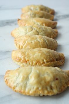 several pastries lined up on a marble surface