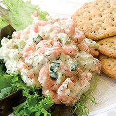 a plate with crackers and salad on it