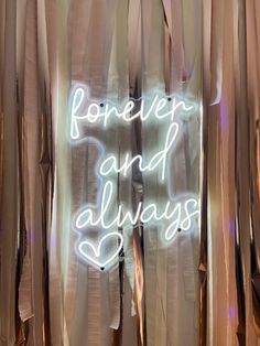 a neon sign that says forever and always on the side of a curtained window