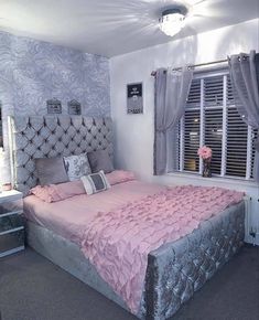 a bedroom with a bed, dresser and window in it's centerpieces