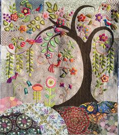 a quilted tree with many different designs on it