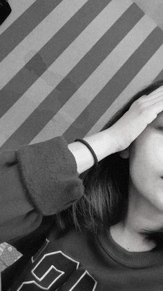 a woman covering her eyes while sitting down