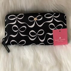 Kate Spade Jae Seaside Dot Continental Wallet *New With Tags *Black With White White Elegant Bow Nylon Printed Exterior *Black Leather And Nylon Interior *Interior: (12) Card Slots, (5) Bill Slots, (1) Zip Slot *Exterior: (1) Slip Slot *Zip Around Closure, Gold-Tone Hardware *Approximate Dimensions: 7.75" X 3.75" X 1" Black Bifold Wallet, Denim Wallet, Leather Trifold Wallet, Card Case Wallet, Black Leather Wallet, Leather Bifold Wallet, Kate Spade Wallet, Leather Bows, Wallet Chain