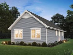 a small gray house with two windows on the front and one window is lit up