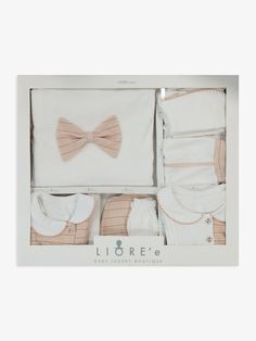 a baby gift set with a bow tie, diaper and bib in a box