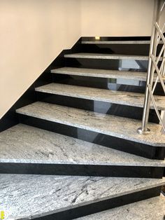 the stairs are made of marble and steel