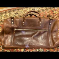 Never Used J. W. Hulme & Co. Brown Leather Duffle Bag. It Is Leather - And Hence Has Normal Discolorations And Slight Markings. Purchased A Few Years Ago For Over $1100. Asking $800 Or Best Offer. Luxury Satchel Travel Bag For Errands, Luxury Tote Duffle Bag For Errands, Luxury Rectangular Duffle Bag For Errands, Designer Rectangular Weekender Bag For Everyday Use, Elegant Rectangular Duffle Bag For Errands, Cognac Rectangular Bag With Palladium Hardware, Rectangular Cognac Bag With Palladium Hardware, Everyday Bag In Bridle Leather With Smooth Grain, Designer Everyday Brown Duffle Bag