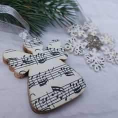 decorated cookies with musical notes on them next to a christmas ornament and snowflakes