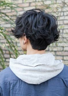 the back of a woman's head with short black hair