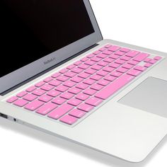 an open laptop computer sitting on top of a white table