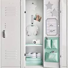 a white locker with headphones and pictures on the wall next to other items in it