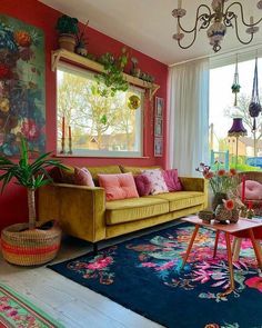 a living room filled with lots of furniture and flowers in vases on the floor