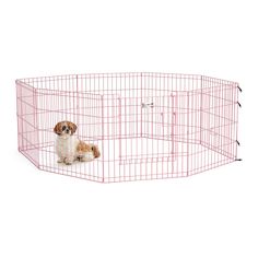 a small dog sitting inside of a pink pet pen