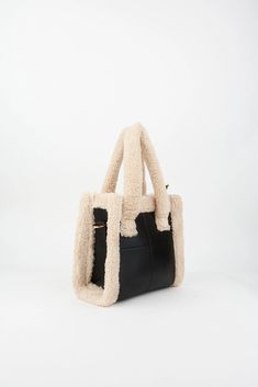 Meet our Faux Fur Tote Bag, where chic meets convenience. Crafted with faux fur and faux leather, it's your go-to for both style and functionality. Adjust the removable strap, zip it up, and carry everything you need in the single spacious compartment--A5 notebook, phone, keychain, card holder, small wallet, and makeup essentials. From hand to shoulder to cross-body, this bag fits your vibe. Elevate your look with our Black Fluffy Tote, the essential Fur Bag for trendsetters like you! Details: Faux fur Faux leather Zip closure Removable and adjustable strap Single compartment A5 notebook, phone, keychain, card holder, small wallet, make-up materials fit. It can be used in the hand, on the shoulder and cross-body. Size: Width: 22 cm (8,6 inches) Length: 24 cm (9,4 inches) Depth: 10 cm (3,9 Chic Box Bag With Zipper Closure For Errands, Faux Leather Satchel With Handles For Errands, Rectangular Shoulder Bag With Faux Fur Lining For Shopping, Chic Rectangular Shoulder Bag With Faux Fur Lining, Black Rectangular Bag With Faux Fur Lining, Trendy Bags With Faux Fur Lining For Daily Use, Trendy Shoulder Bag With Faux Fur Lining, Shoulder Bag With Faux Fur Lining, Leather Bag With Faux Fur Lining