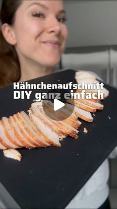 a woman holding up a black tray with slices of meat on it and the words hahrchenaufschmitt diy ganz enfach