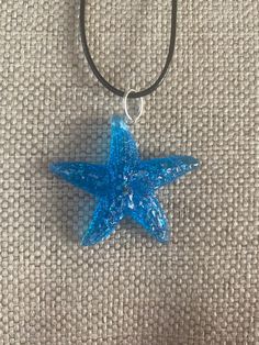 "This gorgeous resin starfish pendant is absolutely stunning. It is a small-medium sized pendant. It is strung beautifully along a black cord with adjustable rings to be between 20-22\" in length and is finished with a lobster clasp. This can be placed on 18-20\" length if requested. This is an absolutely gorgeous pendant and would be a great birthday present, anniversary present, Mother's Day gift, Valentine's Day present, birthday present, or graduation gift. The sleek design of this pendant w Beach Theme Jewelry, Beachy Jewelry, Jewelry Gift Ideas, Present Birthday, Starfish Pendant, Valentines Day Presents, For Her Gifts, Anniversary Present, Beach Theme