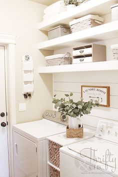 a white washer and dryer in a small room