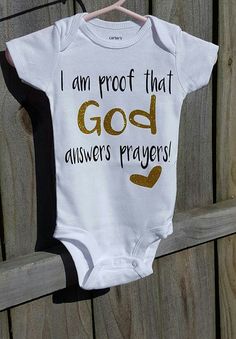 a baby bodysuit that says, i am proof that god answers prayer on it