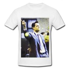 a white t - shirt with a photo of a man in a suit holding a tennis racquet