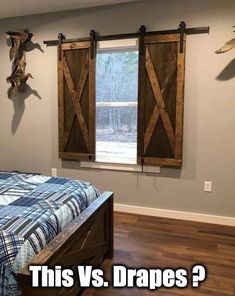 a bedroom with a bed and two wooden barn doors hanging on the wall above it