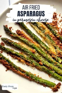 air fried asparagus in parmesan cheese on a white plate with text overlay