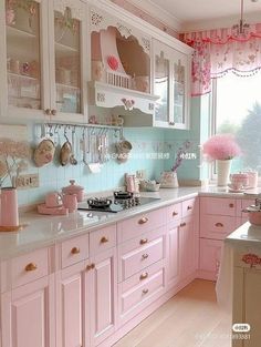 a kitchen with pink cabinets and white counter tops