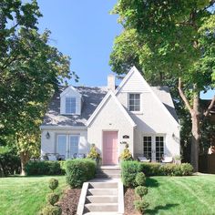 a white house with steps leading up to the front door