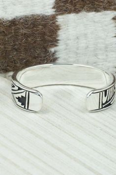 This sterling silver and bracelet was made by Navajo silversmith Kerry Begay. The inside is signed KB and stamped sterling.Size: 5" (will fit up to a 6" wrist)Gap: 1"Width: 1/2"Free shipping on all orders! We ship with USPS and always include tracking. All orders ship within a day of payment.Returns are accepted up to 30 days after you receive your order. Just send us a message. Our shop offers cash back or store credit. The item must be returned in new condition. Etched Sterling Silver Bracelet In Traditional Style, Symbolic Engraved Sterling Silver Cuff Bracelet, Traditional Etched Sterling Silver Bracelet, Stamped Sterling Silver Bangle Bracelet, Stamped Sterling Silver Bangle, Sterling Silver Southwestern Round Cuff Bracelet, Southwestern Engraved Sterling Silver Bracelet Gift, Artisan Sterling Silver Bracelet With Inlay, Southwestern Sterling Silver Round Cuff Bracelet