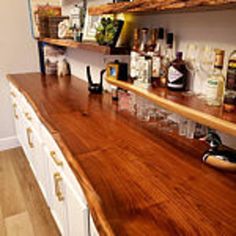 a wooden counter top in a kitchen next to white cabinets