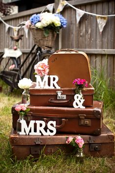 three suitcases stacked on top of each other with mr and mrs cutout letters