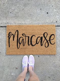 a person standing in front of a door mat with the word marocase written on it