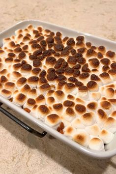 a white dish filled with marshmallows on top of a counter