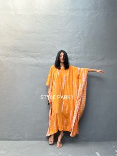 Legian Kaftan Take it easy this season in a simple & relaxed Kaftan that's just as effortless as it is chic. Made with lightweight and breathable rayon voile, loose & easy fit with an eye catching color blocking, this kaftan dress is perfect for every occasion - dressed up or down. * Color -  Tie dye - orange &   motif  * Size  One size  American size From S to L *Total width  /220cm/86inch (round)  Chest & him /150cm/59inch(round)  The length /130cm/51inch * Stylepark1 Model  * Her height is 17 Casual Orange Kurta For Summer, Long Sleeve Orange Kurta For Summer, Orange Long Sleeve Kurta For Summer, Summer Long Sleeve Orange Kurta, Casual V-neck Kurta For Summer, Casual Cotton Free Size Kaftan, Casual Orange Kaftan For Summer, Spring Casual Long Kurta, Casual Long Kurta For Spring