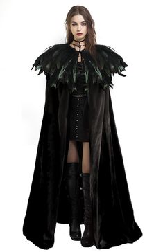 a woman is dressed in black with feathers on her cape