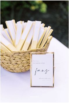 a basket filled with matchesticks next to a sign on top of a table