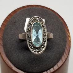 Vintage Sterling with Topaz and Marcasites Ring, Size 8.75. Marked 925 lightly inside band. Main stone is 10 x 5mm. Ring is 21mm wide. No missing stones. Weighs 0.13 ozt.  Are these stones real or fake? Aside from diamonds, we do not know if any gemstones are natural or synthetic. We will state on certain gemstones, that we know 100%, if they are created or fake due to their lack of inclusions. For this reason, we do not sell any diamonds without inclusions, and the larger diamonds (half ct+) are soft graded. In recent years, synthetic gemstones are being created to pass the hardness tests, which is why we state clear rubies and emeralds to be created.  In regards to Star Sapphires, typically, a genuine Star Sapphire's star will follow a light source that is shining on it, while created on European Jewelry, Vintage Fine Jewelry, Star Sapphire, Pure Gold, Selling Jewelry, Light Source, Rings Statement, Jewelry Stores, Statement Rings