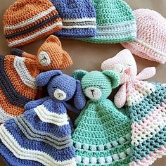 several crocheted hats and teddy bears are arranged together