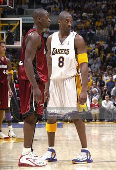 two basketball players standing next to each other on a court