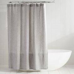 a white bath tub sitting next to a shower curtain