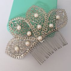 Beautiful silver fan shape hair comb. Silver filigree with pearls . Measurement: about 5.5 inches wide,2.5 inches long . Please contact me if you have any questions. Elegant Silver Headpiece With Teardrop Crown, Elegant Silver Teardrop Crown Headpiece, Traditional Silver Headpiece For Party, Elegant Silver Headpieces For Gifts, Wedding Drop Earrings, Blue Wedding Hair, Pearl Comb, Pearl Cuff Bracelet, Vintage Stud Earrings