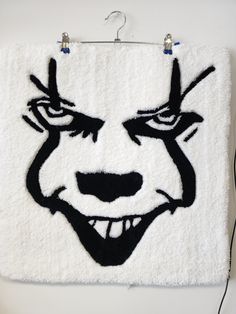 a white towel with an evil face drawn on it