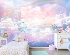 a child's bedroom with pink and blue clouds painted on the wall behind it