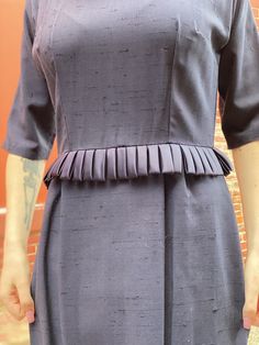 Beautifully detailed 1950s Wiggle Dress in dark Navy with unique satin peplum. In excellent condition. Seems hardly if ever worn. Back metal zip. Measurements Fitted Vintage Dress For Semi-formal Occasions, Fitted Vintage 1950s Dress For Workwear, 1950s Fitted Vintage Dress For Work, Fitted 1950s Vintage Dress For Work, 1950s Vintage Dress For Work, 1950s Style Fitted Vintage Dress For Work, Fitted Pleated Vintage Dress, Fitted Short Sleeve 1950s Dress, Fitted Pleated Vintage Dress, Midi Length