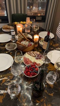 a table filled with plates and wine glasses