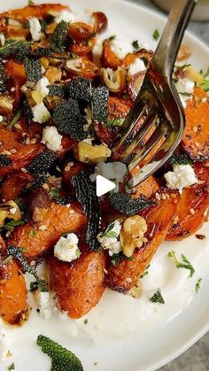 a white plate topped with carrots and feta cheese