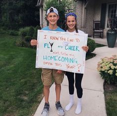 two children holding up a sign that says i know you like to fly and cheer