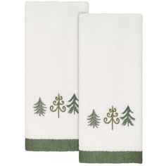 two white towels with green trees on them