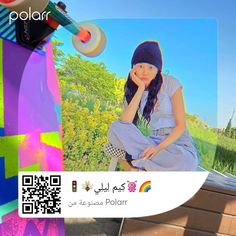 a woman sitting on top of a wooden bench next to a skateboard with a qr code